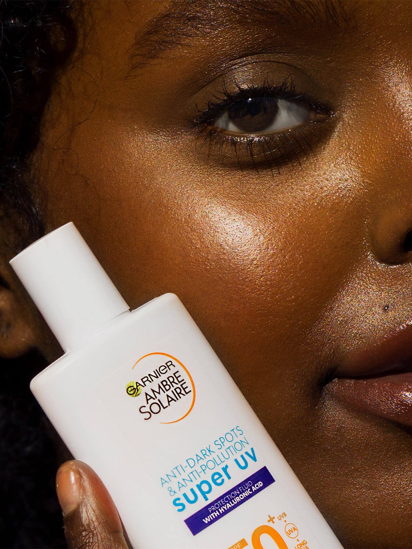 model with Super UV Ambre Solaire Face Fluid product